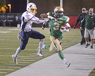 Katie Rickman | The Vindicator.United's Tyler Powers pushes Ursuline's Kimauni Johnson out of bounds during the second quarter at Stambaugh Stadium on Saturday, Nov. 8, 2014.