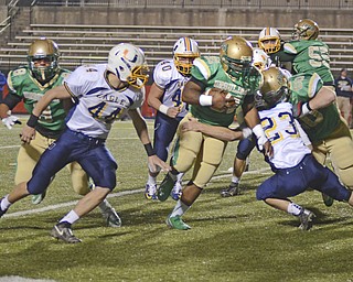 Katie Rickman | The Vindicator.United's Caige Vincent attempts to stop Ursuline's Aaryn Jones (center) from running up field during the first quarter but fails during the game at Stambaugh Stadium on Saturday, Nov. 8, 2014..