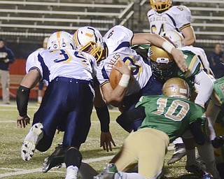 Katie Rickman | The Vindicator.United's Coltan Antram is tackled by Ursuline's Spencer Warren (number 44) and Dawalyn Washington (10) during the first quarter during the game at Stambaugh Stadium on Saturday, Nov. 8, 2014.