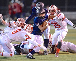 Jeff Lange | The Vindicator Fitch's Tyler Hewlett (31) cruises through a gauntlet of Grizzly defenders during his 55-yard run that put the Falcons in scoring position early in their regional quarterfinal, Friday night.
