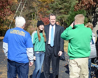Katie Rickman | The Vindicator .Paige O'Brien, 15,  poses for a photo with Ed FitzGerald, Democratic canidate for Governor as her father Sean O'Brien takes her picture at Niles United Methodist Church where FitzGerald stopped to meet voters on Tuesday, Nov. 4, 2014.