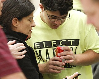        ROBERT K. YOSAY  | THE VINDICATOR..Friends and son james  look at an I phone as results come in for  Susan Maruca .. early on election night at St Lukes Church -