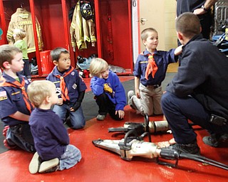        ROBERT K. YOSAY  | THE VINDICATOR..Cub Scout troop Den 5 from Canfield United Methodist Church - as they toured the Canfield Fire Dept. Colton Burns 2 Josh Burns 6  Ryan Dango 6 Brennon (ok) Mitchell 7 and Will WIres 6 look at the jaws of life as firefighter Shawn Fiffick ..