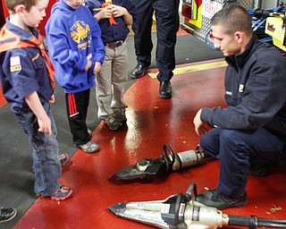        ROBERT K. YOSAY  | THE VINDICATOR..Cub Scout troop Den 5 from Canfield United Methodist Church - as they toured the Canfield Fire Dept.  Ryan Dango 6 Brennon Mitchell 7 and Will WIres 6 look at the jaws of life as firefighter Shawn Fiffick ..