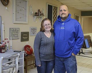 Katie Rickman | The Vindicator.Ashli Zinkhon and her boyfriend Adam Ruess pose for a photo inside their new business "Ashli's Attic" in Struthers on Wed. November 5, 2014.