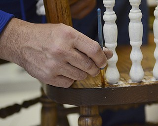 Katie Rickman | The Vindicator.Adam Ruess works on a chair inside the business that he recently started with his girlfriend Ashli Zinkhon in Struthers on Nov. 5, 2014.