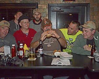 Katie Rickman | The Vindicator.Burger Guyz crowd around Fast Freddie from 93.3 the Wolf at The Pour House Bar and Grill in Canfield on Wednesday, Nov. 5, 2014...Left to right.Scott Long, Anthony Fuda, Fast Freddie, Jim Murphy, JT Tranovich..back row.Eric Tranovich and James Chizmark