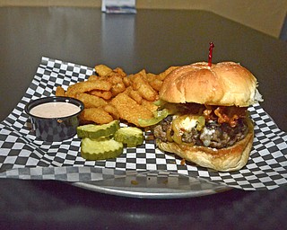 Katie Rickman | The Vindicator.The "Try It With" burger with crispy bacon, caramelized hot peppers, and romano and melted jack cheese at the Pour House Bar and Grill in Canfield...burger runs for $8.99.