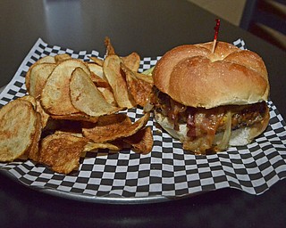 Katie Rickman | The Vindicator.The BBQ and Bacon burger with grilled onions and melted cheddar cheese at The Pour House Bar and Grill in Canfield...buger runs for $8.99