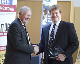 Katie Rickman | The Vindicator.Richard Sheridan, Emerging Leaders Instructor shakes hands with Craig Marshall who graduated from the program with 16 others on Wed. November 5, 2014.