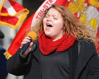 Jeff Lange | The Vindicator KSU student Brittany Best belts out the Star Spangled Banner prior to the start of the 23rd annual Laying of the Roses held at the Youngstown Vietnam Memorial, Sunday afternoon.