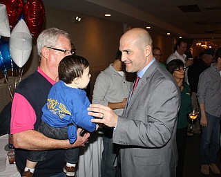        ROBERT K. YOSAY  | THE VINDICATOR..Mauro Cantalamessa, right, greets his 13-month-old son, Benito, who  .is being held by Cantalamessa's father-in-law, Mark MacDonald of  .Twinsburg, Tuesday night at Enzo's Restaurant. Cantalamessa, 37,  .manager of the restaurant, was elected Tuesday to fill the last two  .years of the unexpired term of Paul Heltzel as Trumbull County  .commissioner.