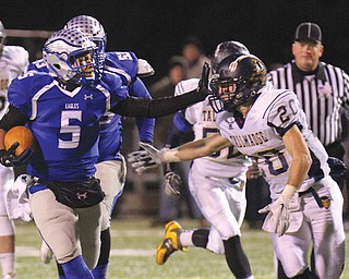 Hubbard quarterback Cam Ingram holds back Tallmadge’s Quentin Teeling during their Division V regional quarterfinal Friday in Hubbard. The Eagles soared over the Blue Devils, 45-14, to become one of eight Valley teams to make it into Round 2 of the playoffs.