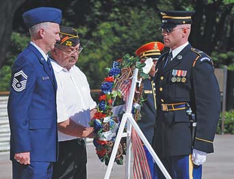 Members of VFW Triangle Post 2799 in New Springfield recently placed a wreath at the Tomb of the Unknown Soldier in Arlington National Cemetery, Va. Presenting the wreath, created by C&C Ribbons and Florist of Boardman, are, from left, Air Force Reserve Senior Master Sgt. David Olekshuk of New Middletown, chaplain
of Post 2799; David Coss of New Middletown, post commander; and a member of the 3rd U.S. Infantry Regiment, which guards the tomb.