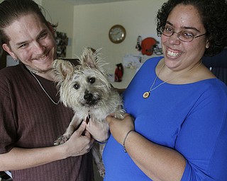        ROBERT K. YOSAY  | THE VINDICATOR..BENJI is saved as the  Lisa and Corey Mercer hold him after the surgery.... etc..-30-.