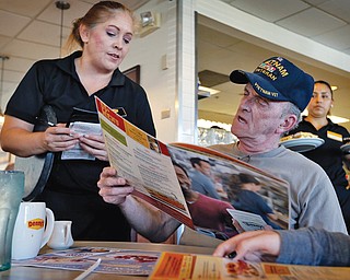 Retired U.S. Navy Vietnam veteran Larry Woodrome orders a free lunch Tuesday at Denny’s in Gilbert, Ariz. Denny’s gave away free lunches to military veterans on Veterans Day.