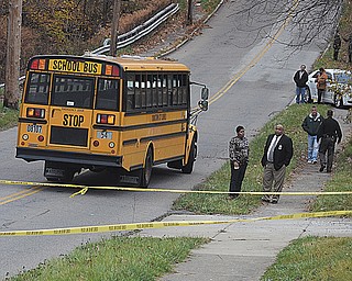 Youngstown East High School officials and city police traffic investigators check out the scene of an accident in which a school bus struck and killed student Faith McCullough-Wooster. The incident occurred Wednesday on East High Avenue.