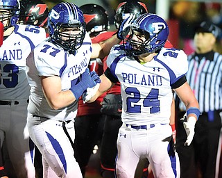 Poland’s Austin Wilson (24) of Poland is congratulated by teammate Joe Bonarigo (77) after scoring a touchdown during their Week 10 game against Canfield in Canfield. Wilson, a senior, has emerged as a potent complement to Marlon Ramirez with a level of speed that not many opponents can catch, says coach Mark Brungard. On Friday, the Bulldogs are getting another shot defending state champ St. Vincent-St. Mary in a Division III regional semifinal.