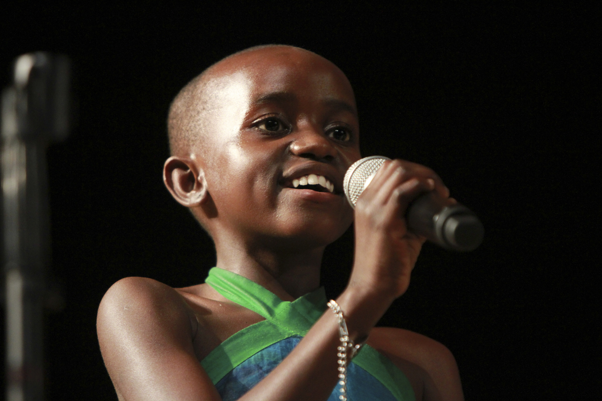 William DLewis the Vindicator  SRebecca Tendo sings Amazing Grace with African children's Choir during 11-13-14 performance at  Powers Auditorium in Youngstown.