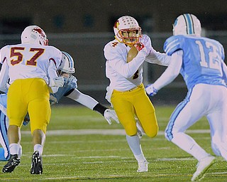 Jeff Lange | The Vindicator  Mooney's junior running back Anthony Gill (4) weaves through Benedictine defenders in the first quarter of their regional semifinal matchup, Friday night at Revere High School.