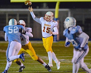 Jeff Lange | The Vindicator  Cardinal Mooney's quarterback Jon Saadey (15) releases a pass to a receiver during first half action against Cleveland Benedictine at Revere High School, Friday night.