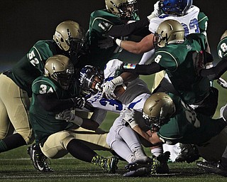 Akron St. Vincent-St. Mary defenders Eric Bentley (52), Dre'k Brumley (34), Kyle Kelly (6) and Patrick Oliverio (36) gang-tackle Poland running back Marlon Ramirez during first quarter action in their Division III Region 7 high school playoff football game at Lake High School on Friday, Nov. 14, 2014, in Uniontown, Ohio. (Ed Suba Jr./Akron Beacon Journal)