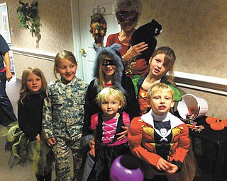 SPECIAL TO THE VINDICATOR Whispering Pines Village in Columbiana had its annual night of Halloween trick-or-treating for the residents’ families and friends. Resident Mary Davis and her black cat passed out candy. The children are Haley Stull, Nevaeha Merriman, Isaiah Stull, 
Hannah Hibbs, Kiersten Burton and Bryleigh Burton.