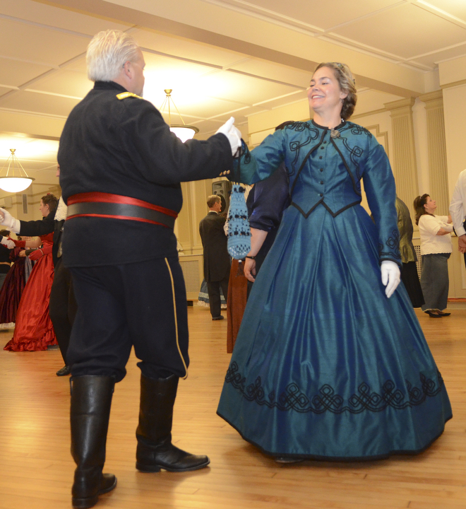 Katie Rickman | The Vindicator .Ron Orkis dances with his wife Dr. Holly Ray, both of Chardon, Ohio as the band plays the Lancer's Quadrille 1st Figure during The Governor David Tod Civil War Ball at the Tyler History Center in Youngstown on Saturday, Nov. 1, 2014.