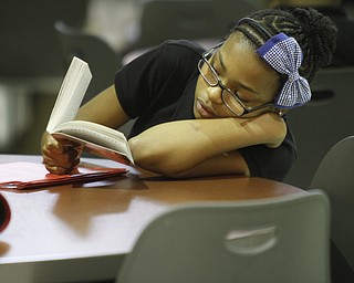        ROBERT K. YOSAY  | THE VINDICATOR..Discovery at Volney 3- 8th grade - ..Silent reading time... after lunch in the cafeteria....Aleah Lampley 7th grader...  reads... and relaxes..-30-.