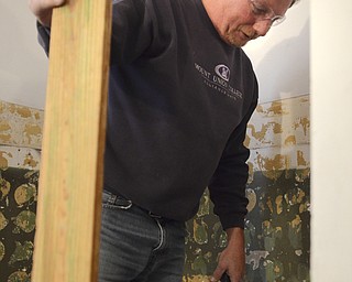 Katie Rickman | The Vindicator.Bill Rohaley of Salem works in the bathroom at the home of Charles Carson, a disable veteran in his Canfield home on Friday Nov. 7, 2014.  Rohaley is one of 12 Home Depot Volunteers who will work at the home to complete a wheel chair ramp as well as renovate the bathroom Friday Nov 7- Saturday, Nov. 8.