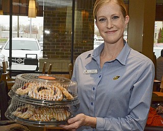 Katie Rickman | The Vindicator.Abigail Fink, Assistant Manager at the Austintown Panera Bread brings out trays of pastries to give to Ken Jackubec and Jack Kidd to distribute to veterans on Friday, Nov. 7, 2014.