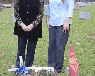 Katie Rickman | The Vindicator.Karen Hoye, left, stands next to her daughter Stacey Hoye Jarrell at the grave of her son Thomas Hoye in Lowellville on Saturday, Nov. 8, 2014.