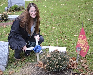 Katie Rickman | The Vindicator.Stacey Hoye Jarrell at the grave of her brother Thomas Hoye in Lowellville on Saturday, Nov. 8, 2014.  There is a benefit to help raise money for a tombstone for the grave because they family has not been able to afford one.