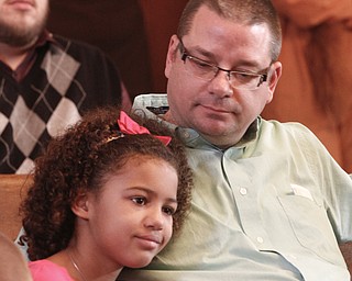        ROBERT K. YOSAY  | THE VINDICATOR..Trumbull County Court annual Adoption Day...Happy dad and daughter as Marshayla Meyer 7 who was adopted in a prior year ...with here dad Rodd Meyer....as they watch the proceedings for the adoption of two more Johnathan and Deon...two new brothers