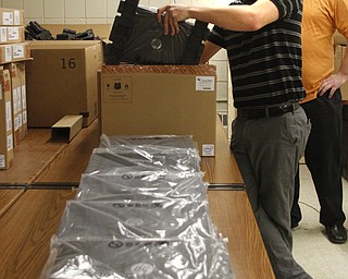       ROBERT K. YOSAY  | THE VINDICATOR..Austintown  Fitch Students willbe getting HP Chromebooks soon as part of a schoolwide program ...   YSU students help unpack the more then 1200 books  Brandon Nutter  of Hubbard and Tim Gaudio of North Lima both YSU ..unpack the Chromebooks