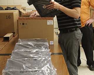        ROBERT K. YOSAY  | THE VINDICATOR..Austintown  Fitch Students willbe getting HP Chromebooks soon as part of a schoolwide program ...   YSU students help unpack the more then 1200 books  Brandon Nutter  of Hubbard and Tim Gaudio of North Lima both YSU ..unpack the Chromebooks