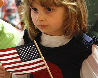        ROBERT K. YOSAY  | THE VINDICATOR..Taylor Logan .. kindergarten looks at her flag as the colors of the flag and its history are explained...Stadium Elementary - Boardman