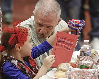        ROBERT K. YOSAY  | THE VINDICATOR..Reading a thank you note to her grandfather Lorin Sam a first grader - and Jim Hriel( Navy)..Stadium Elementary - Boardman