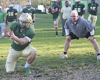 Vito Penza catches rthe snap for a place kick while ursuline HC Larry Kempe looks on during 11112014 practice.