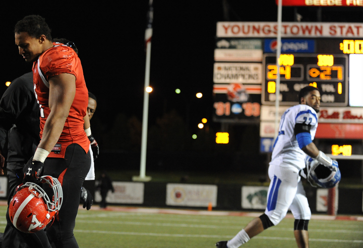 YOUNGSTOWN, OHIO - NOVEMBER 15, 2014:Derek Rivers #11 of YSU walks off the field after a game winning Indiana State field goal at the end of Saturday nights game.(Photo by David Dermer/Youngstown Vindicator)