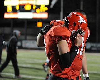 YOUNGSTOWN, OHIO - NOVEMBER 15, 2014: Hunter wells #6 of YSU is consoled by teammate Justin Spencer #61 after a game winning Indiana State field goal at the end of Saturday nights game.(Photo by David Dermer/Youngstown Vindicator)