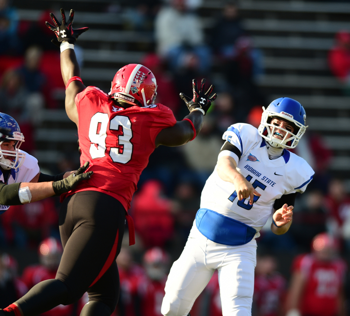 YOUNGSTOWN, OHIO - NOVEMBER 15, 2014:Mike Perish #15 of Indiana State throws a pass while avoiding pressure from Emmanuel Kromah #93 of YSU during the 1st half of Saturday afternoons game at Stambaugh Stadium. (Photo by David Dermer/Youngstown Vindicator)