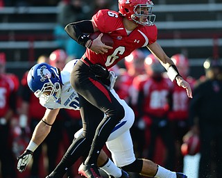 YOUNGSTOWN, OHIO - NOVEMBER 15, 2014: Hunter Wells #6 of YSU is brought down by Mark Sewall #21 of Indiana State behind the line of scrimmage during the 1st half of Saturday afternoons game at Stambaugh Stadium. (Photo by David Dermer/Youngstown Vindicator)