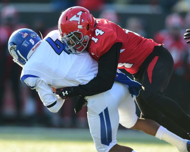 YOUNGSTOWN, OHIO - NOVEMBER 15, 2014: Gary Owens #4 of Indiana State is tackled by Eric Thompson #14 of YSU during the 1st half of Saturday afternoons game at Stambaugh Stadium. (Photo by David Dermer/Youngstown Vindicator)