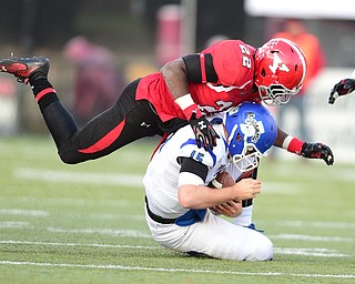 YOUNGSTOWN, OHIO - NOVEMBER 15, 2014: Mike Perish #15 of Indiana State is sacked by Dubem Nwadiogbu #22 of YSU during the 2nd half of Saturday afternoons game at Stambaugh Stadium. (Photo by David Dermer/Youngstown Vindicator)
