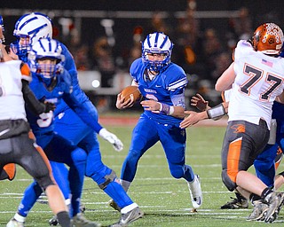 Jeff Lange | The Vindicator  Blue Devils QB John Clegg (center) runs through a host of Lucas and Reserve players in the second quarter of Friday night's game in Orrville.