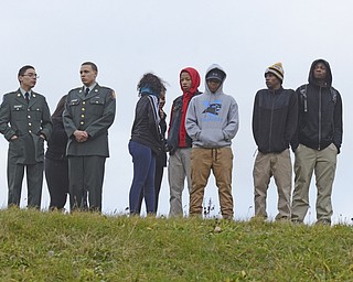 Katie Rickman | The Vindicator.Students from East High School stand on top of a hill where freshman Faith McCullough-Wooster was killed after being struck by a school bus on Wednesday, Nov. 12, 2014 in Youngstown, Ohio.