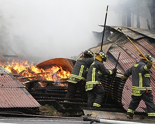        ROBERT K. YOSAY  | THE VINDICATOR..a barn fire destroyed a barn on Harbor EdinburgRd in Lawrence county as area firefighters responded to the fire including the Poland Fire Dept that brought its aerial truck ..Poland Firefighters  Gio Melia William Ziegler Vincent Caggiano..  work on hot spots