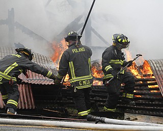        ROBERT K. YOSAY  | THE VINDICATOR..a barn fire destroyed a barn on Harbor EdinburgRd in Lawrence county as area firefighters responded to the fire including the Poland Fire Dept that brought its aerial truck ..Poland Firefighters  Gio Melia William Ziegler Vincent Caggiano..  work on hot spots