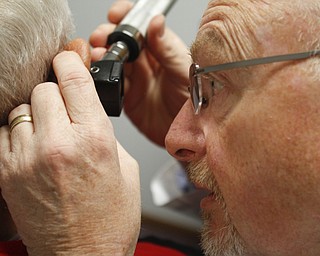        ROBERT K. YOSAY  | THE VINDICATOR..Dr. Eric Hagberg, audiologist, and patient. Hearing Innovations, .Story combines Dr. ERic HagbergÕs effort to gain equal status with chiropractors, dentists, etc. in treating his Medicare patients/ and a mission to China  .Peter Anania  gets his ears checked...by Dr Hagberg..on an annual check up